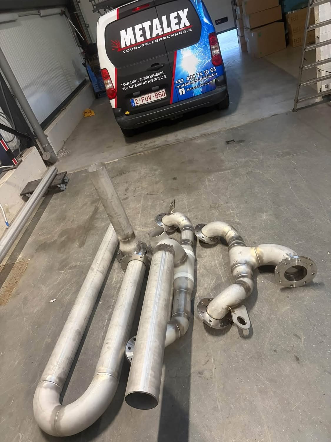 Lignes de tuyauterie inox à brides soudées, posées devant la camionnette Metalex